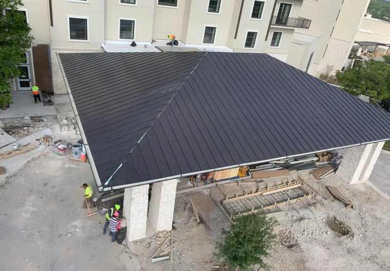 Metal roofing installation team working on a commercial building in Jefferson